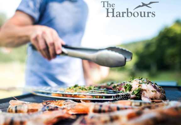 A person grilling food with a spatula in their hand.