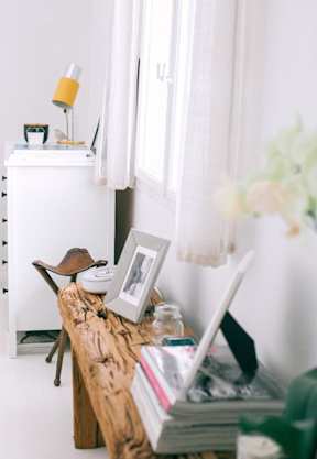 A home office featuring a wooden table with a picture frame placed on it.