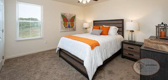 a bedroom with a bed and a ceiling fan