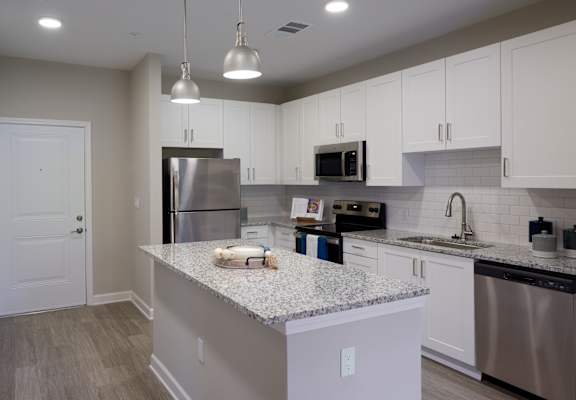 a kitchen with granite counter tops and stainless steel appliances