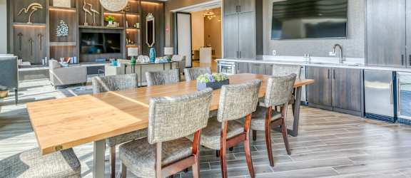 a dining room with a wooden table and chairs
