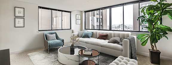 A living room with a bar area and a view of the city.