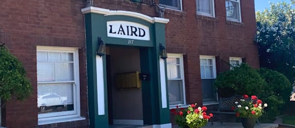 a red brick building with a sign that reads laird