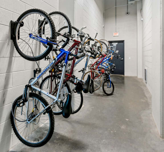 a row of bikes hanging on a wall in a building