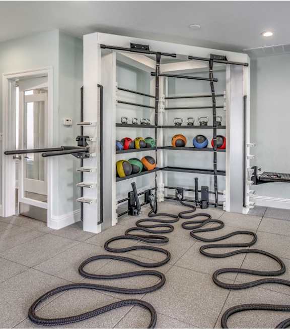A room with a white door and a black screen on the wall.