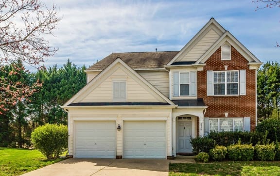 a brick house with a white garage door