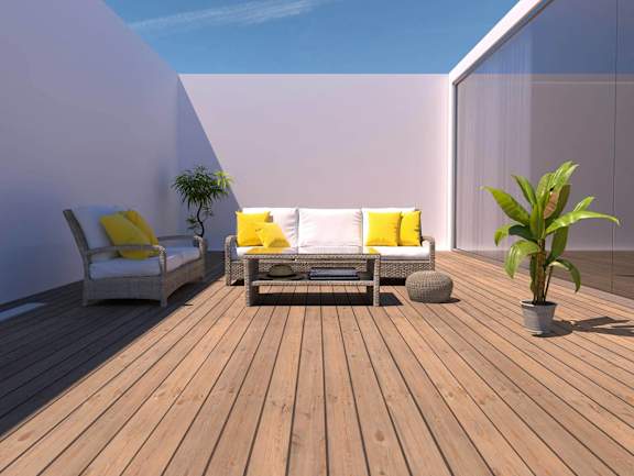 A wooden deck with two chairs and a table.