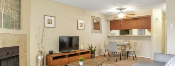 a kitchen with green cabinets and a bar with stools