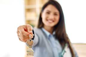 A woman in a business suit is holding a set of keys. at Park at Forest Hill Apartments, Memphis