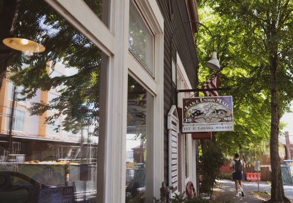 a street view of a restaurant with a sign on the side of a building at Liza Apartments, Seattle, Washington, 98102