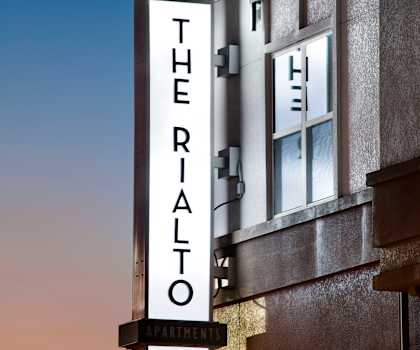 a sign on the side of a building that reads thrasher apartments at The Rialto, Florida, 32819