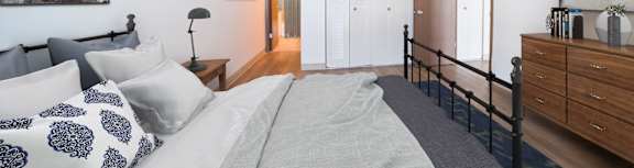 A bedroom with a large bed and a painting on the wall at Highpoint Towers Apartments, Pennsylvania