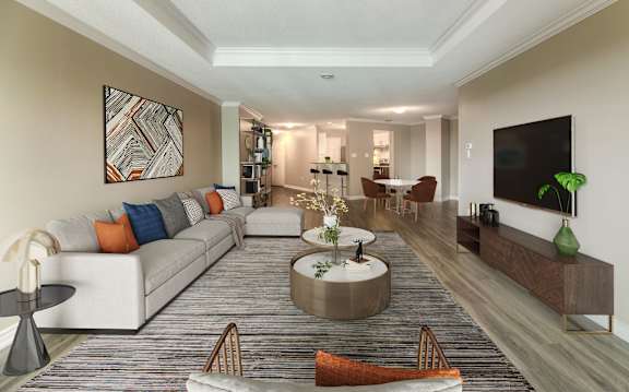 A living room with a white couch and a grey coffee table.