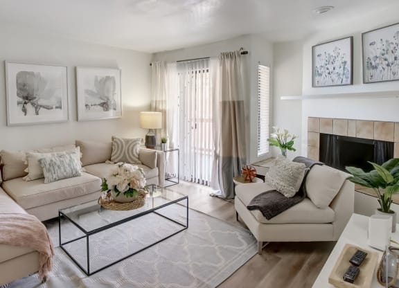 a living room with two couches a coffee table and a fireplace at Glen at Mesa Apartments, Arizona 85201