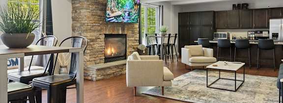 A modern living room with a fireplace and a dining table.