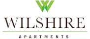 The logo for Wilshire Apartments with a green V on a white background