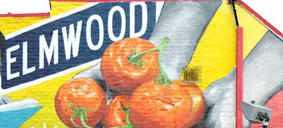 A mural of a hand holding tomatoes with the word "ELMWOOD" above it.