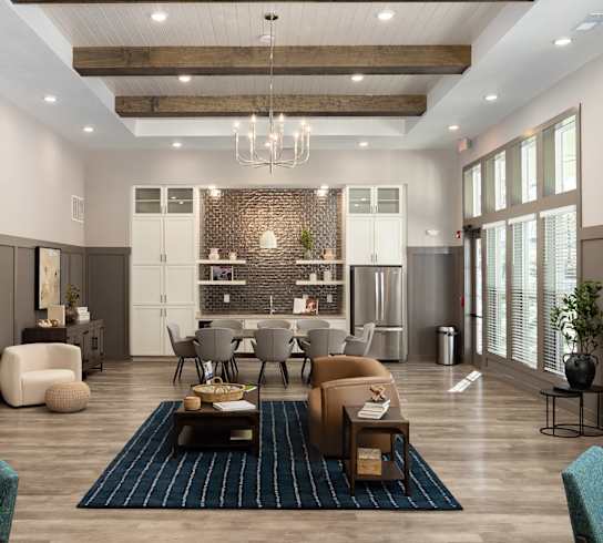 a large living room with a large table and chairs