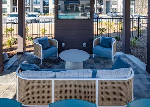 a patio with a table and chairs and a tv