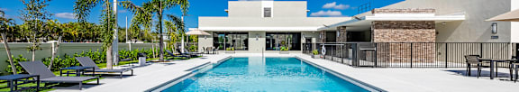 A large outdoor swimming pool surrounded by a fence.