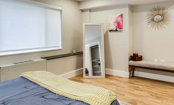 large bedroom with large windows and custom closets