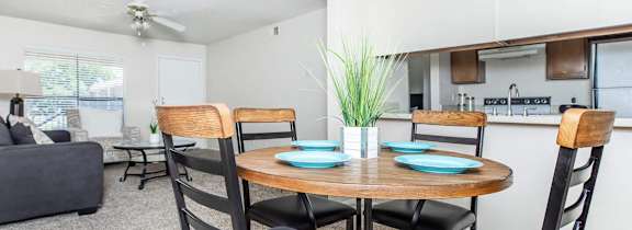a dining room and living room with a table and chairs