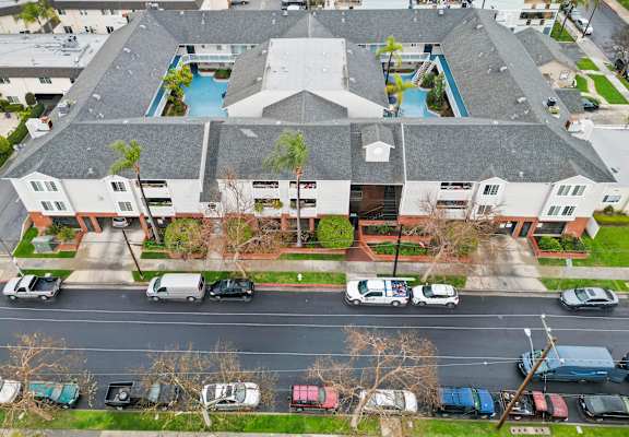 An aerial view of a building with a pool in the center.