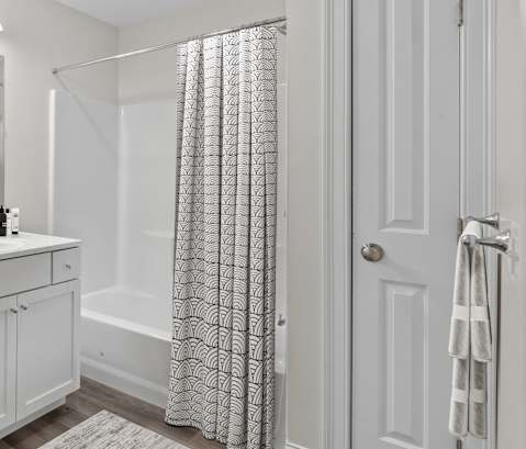 a bathroom with a white sink and toilet and a shower