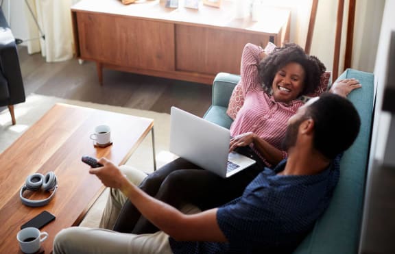 Resident Couple in Living Room at Montclair Apartments, 20904