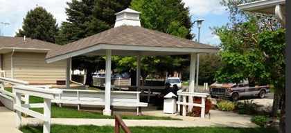 A gazebo is in the middle of a grassy area.