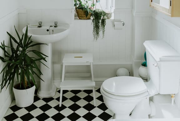 a bathroom with a white toilet next to a sink
