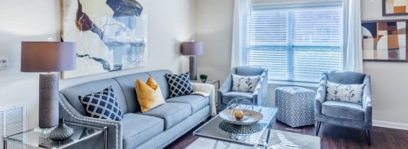 a living room with a couch and a ceiling fan
