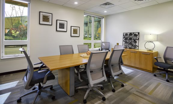 a conference room with a table and chairs