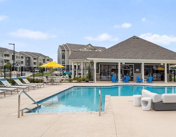 A large swimming pool with a gazebo in the background.