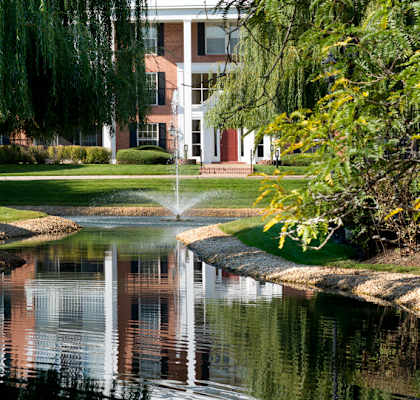 a pond with a fountain in front of a building at Versailles on the Lakes Oakbrook*, Oakbrook Terrace, 60181