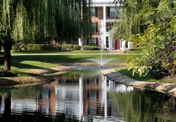 a pond with a fountain in front of a building at Versailles on the Lakes Oakbrook*, Oakbrook Terrace, 60181
