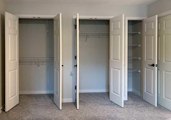 three bedroom closet doors are open