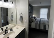 Thumbnail 25 of 27 - a bathroom with a sink and a mirror at The Lodge Apartments, Tulsa