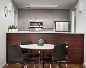 Table and chairs in front of kitchen and counter top