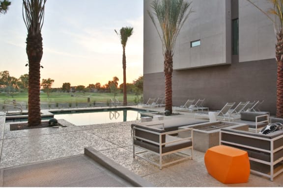 Apartments in Scottsdale-Dusk Scottsdale Swimming Pool with Lounge Chairs, a Fire Pit, and Amazing Views