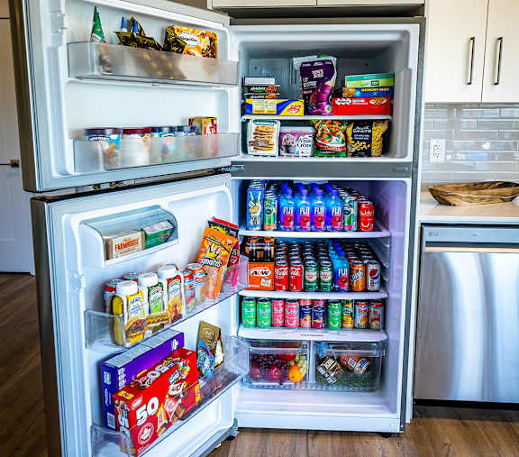 an open refrigerator filled with food and drinks