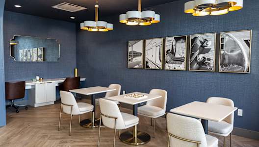 A dining room with white chairs and a table.