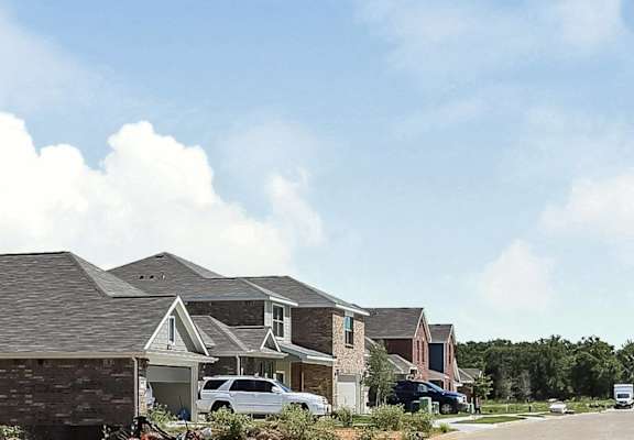 a row of houses on a street under a blue sky