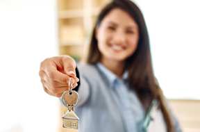 A woman in a business suit is holding a set of keys at Grays Creek Apartments, Cordova, TN, 38018