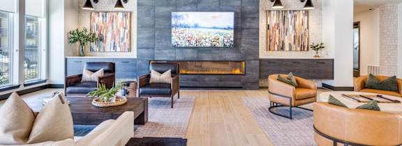 A modern living room with a fireplace and a large window.