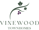A logo for Vinewood Townhomes with a vine and grapes.