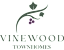 A logo for Vinewood Townhomes with a vine and grapes.