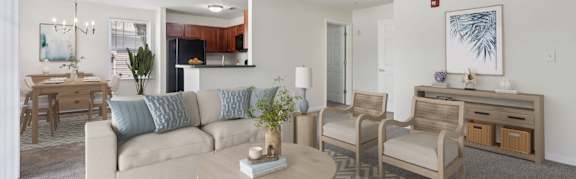 A living room with a couch, chairs, and a coffee table.