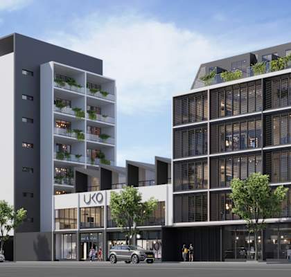 A modern building with a glass facade and a sign that reads "IKO".