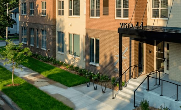 A multi-story apartment building with the name "VISTA 441" on the front.